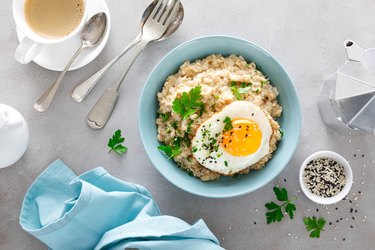 Savory muscle-building oatmeal with fried eggs sunny side up for breakfast