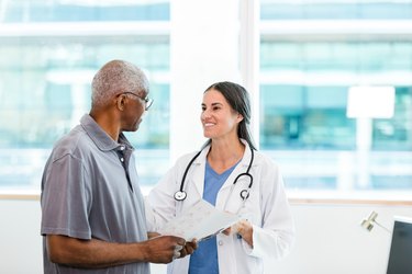 Female doctor and senior patient discuss the effects of acidity or acid on body