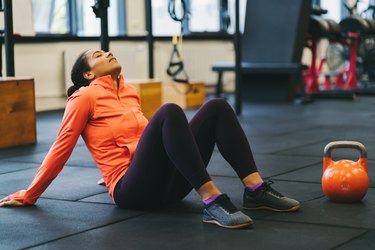 Exhausted person in gym demonstrating someone who wants to quit their fitness New Year's resolution