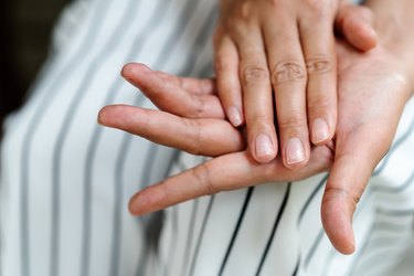 close view of a person's nails, to represent aging nails