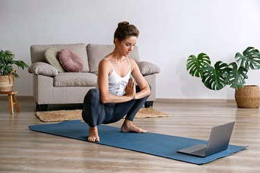 woman doing malasana pose at home to stretch tight pelvic floor