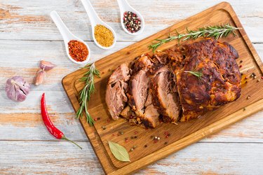 Deep-fried pork shoulder cut on slices on chopping board