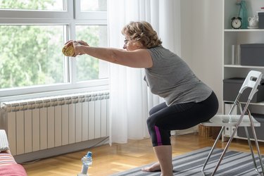 senior women doing the sit-to-stand exercise as one of the best seated exercises for older adults