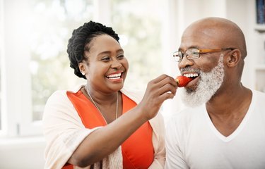 An older couple eating fruit to stay hydrated