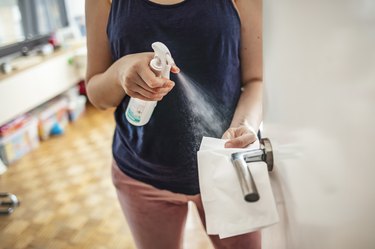 A woman using safe cleaning products during the COVID-19 pandemic