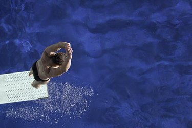 overhead shot of competitive diver on springboard