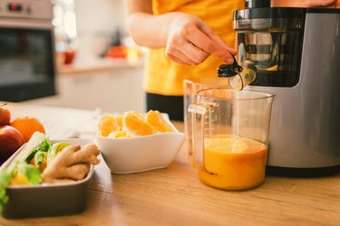 Woman making cold-pressed juice