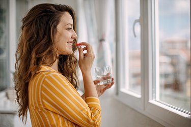 young adult woman taking non-constipating iron supplement