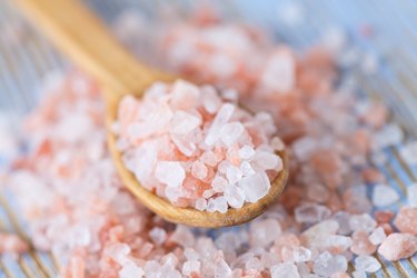 himalayan pink salt on wooden surface