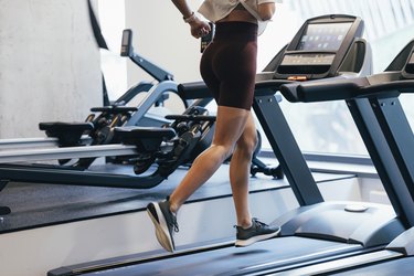 Anonymous Sportswoman Running on a Treadmill at the Gym