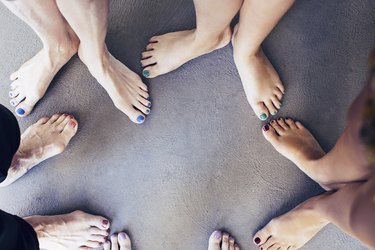 A close-up of bare feet in a circle.