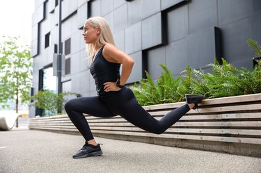 Woman doing lunges outside to fix glute imbalance