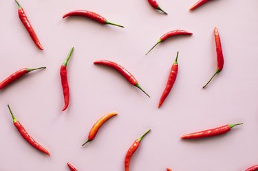 Red chili peppers on pink background