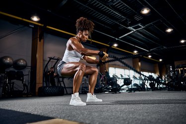 Woman exercising with ropes in a gym