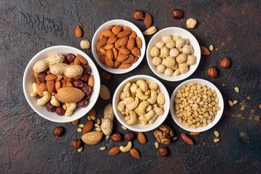 Bowls with almond, hazelnut, walnut, peanut, cashew and pine nuts