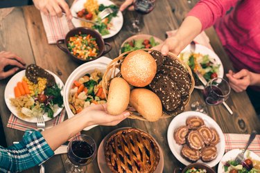 Hands passing a bread basket