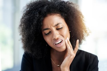 Woman with jaw pain from teeth grinding