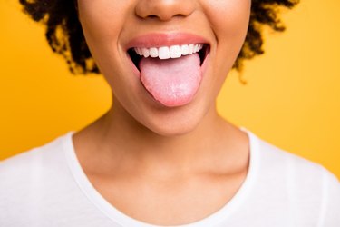 Cropped close up photo of a person sticking out their tongue, showing their taste buds