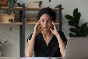 Tired young person overwhelmed with computer work