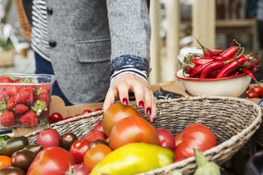 Close up of hand picking produce from a basket, as a concept of eating vitamins, a natural remedy for cough