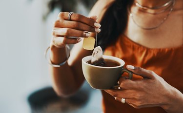 a woman brewing tea, as a stye remedy