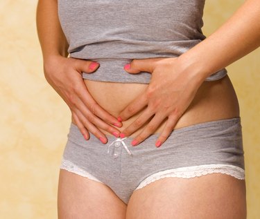 Woman with bloated tummy, close up