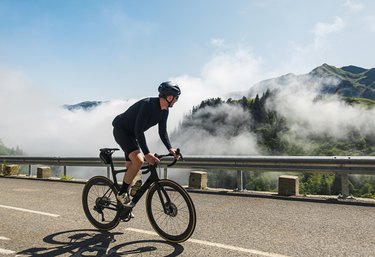 Cyclist on a long bike ride on the Col de la Colombiere in the French Alps