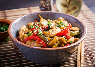 Stir fry chicken, zucchini, sweet peppers and green onion. Asian cuisine