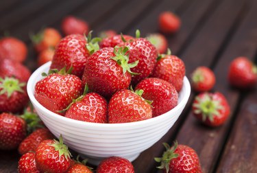 Potassium-rich strawberry on wooden background. Copy space