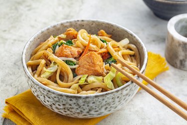 Salmon Fish and Stir Fried Yaki Udon Noodles with Vegetables and Soy-based Sauce.