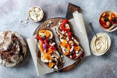Roasted vegetables open faced sandwich with hummus and feta cheese