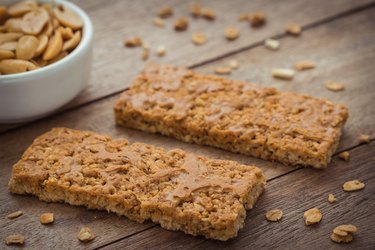 Granola bars on wooden table and peanuts