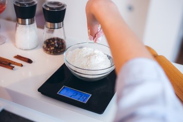 Measuring flour on a kitchen food scale.