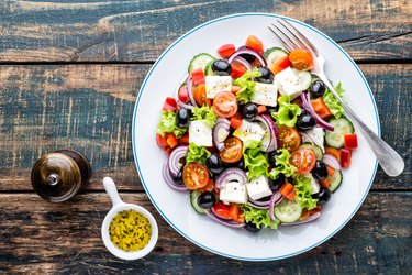 top view of a bowl of greek salad, as an example of food on an obesity diet plan