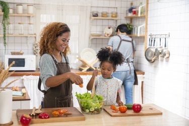Woman and her daughter preparing a meal that's part of a healthy eating plan.