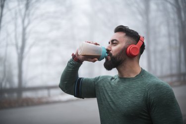 Man Drinking a Low-Carb Protein Shake After Exercising Outdoors
