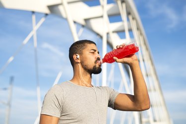 athlete drinking energy drink after training and experiencing frequent urination