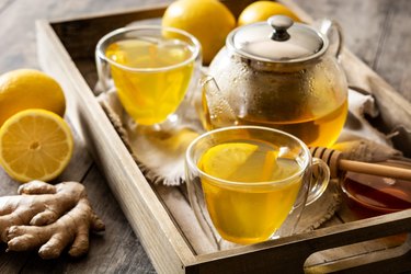 Ginger tea with lemon and honey in crystal glass