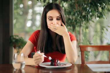 Woman Feeling Sick From Eating Chocolate Cake