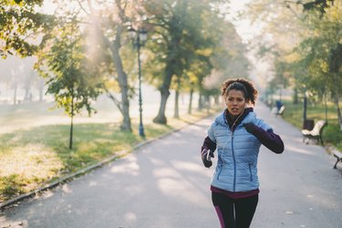 Woman jogging in autumn park