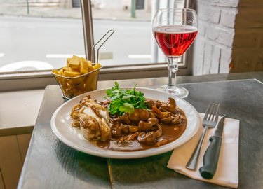 A dish of veal kidneys with juniper berries and juniper vodka enever. Also fries and ruby beer. A traditional Belgian dish