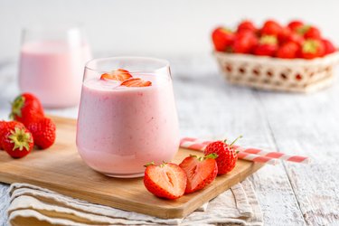 Berry-Morning Breakfast Smoothie on table with sliced strawberries