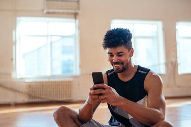 Man texting on his phone during a workout