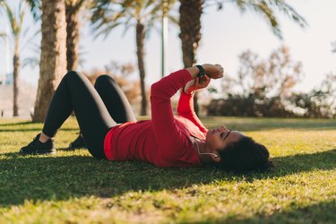 Sportswoman checking pulse on smartwatch