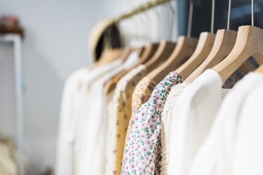 Rack of clothing on hangers to show that dresses do get longer with size and what are 3 sizes of average women's pant size