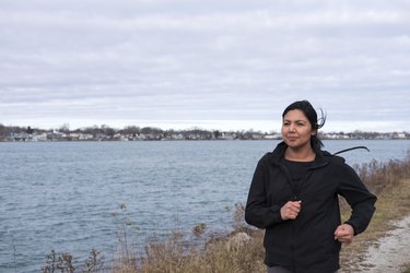 Person running outdoors along a lake