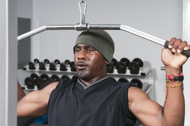 Man Using Lat Pulldown Machine