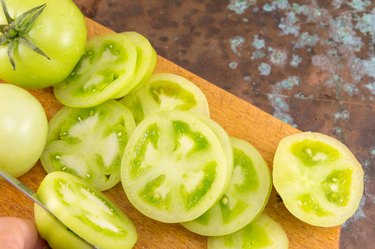 green tomatoes on a cutting board