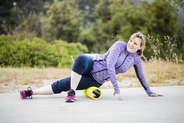 Young Woman Exercising with Foam Roller