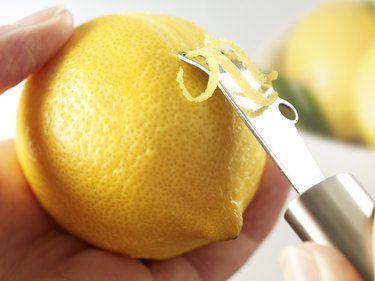 close view of someone peeling a lemon